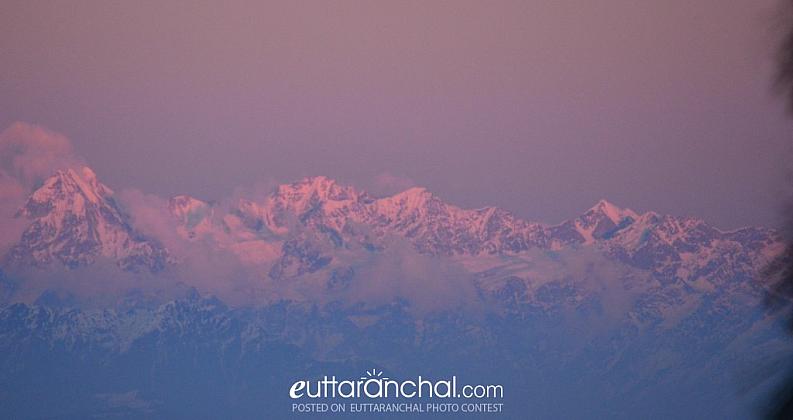 Snow clad Nandadevi range gets soaked in violet ray from setting sun
